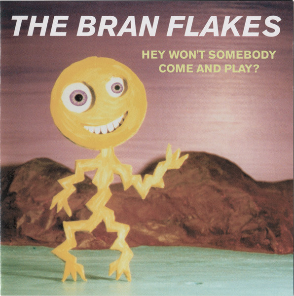  The album cover for Hey Won't Somebody Come and Play?. The picture is of some kind of cardboard diorama of a yellow stick figure with zigzag limbs standing in a field with wavy mountains in the back.